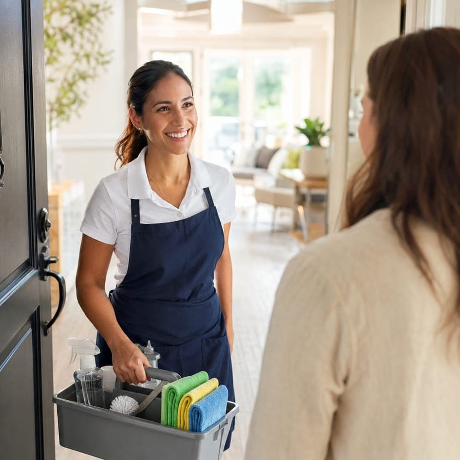 A home services provider greeted at the door by a client